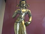 British Museum Top 20 Buddhism 16-1 Vajrasattva 16. Vajrasattva  Nepal, 15C AD, 52cm high. The gilded bronze standing figure holds the vajra and bell in his hands, has elaborate jewelry, and is inset with semi-precious stones. In Vajrasattva's crown is the seated figure of the Akshobhya, the Tathagata Meditation Buddha of the East.